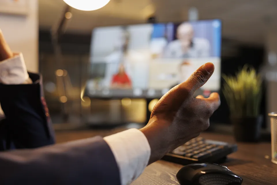 A person discussing a video call at a desk